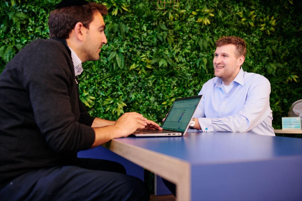 Two ITD Global team members reviewing shipping data together