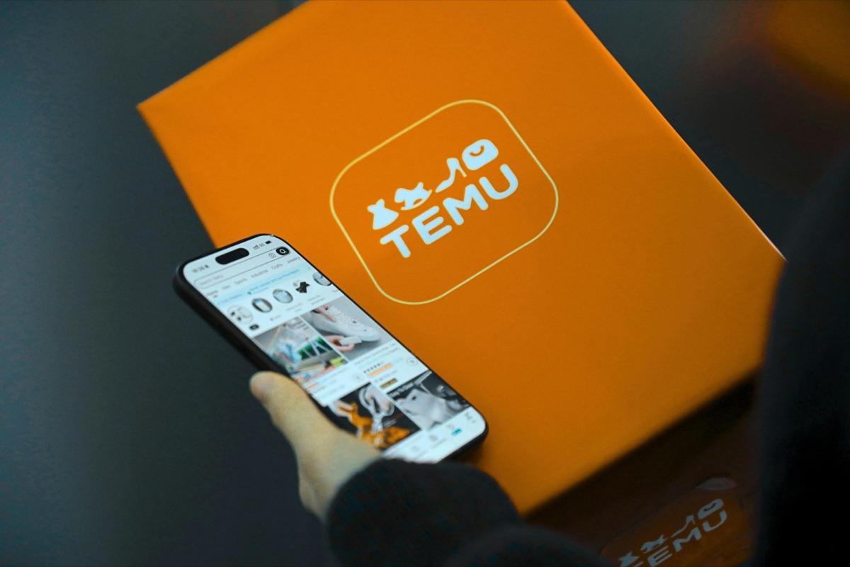 Shopper browsing the Temu app next to a Temu-branded box — cross-border marketplace orders