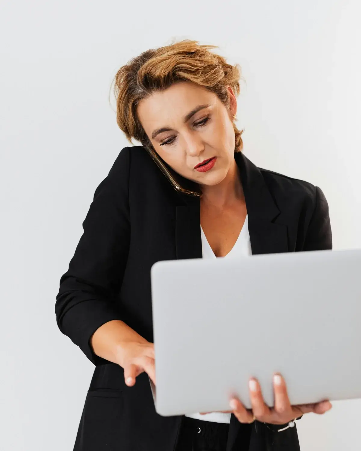 Account manager on the phone resolving a carrier issue on a laptop
